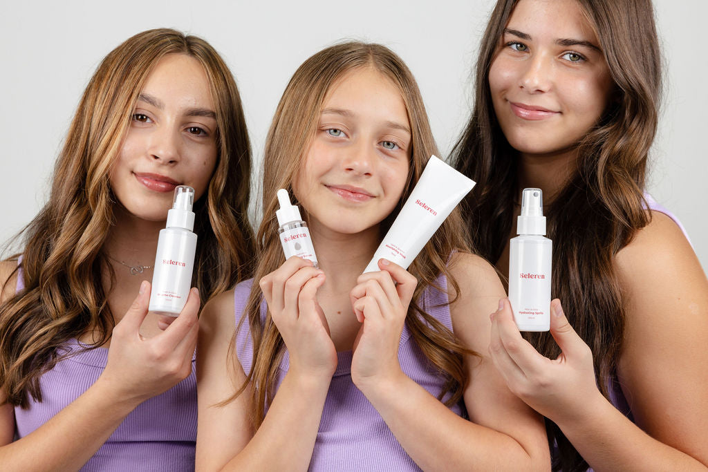 Three teen women holding Seleren skincare products against a plain background
