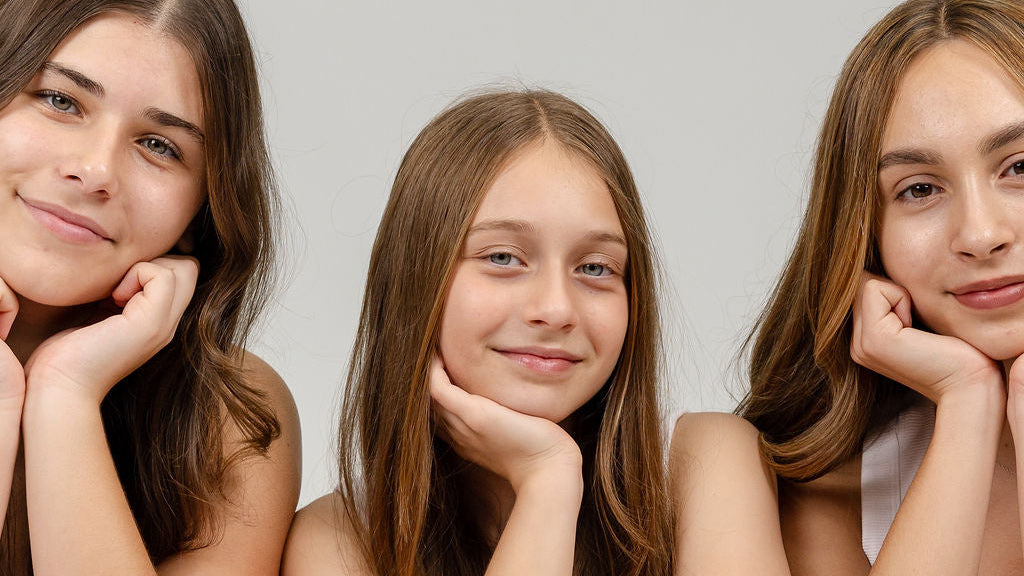 Three tween women with skincare products on a white background